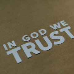 a brown box with a sticker that says in god we trust